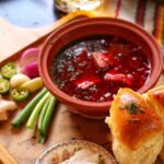 Ukrainian borscht served with sour cream and garlic pampushky