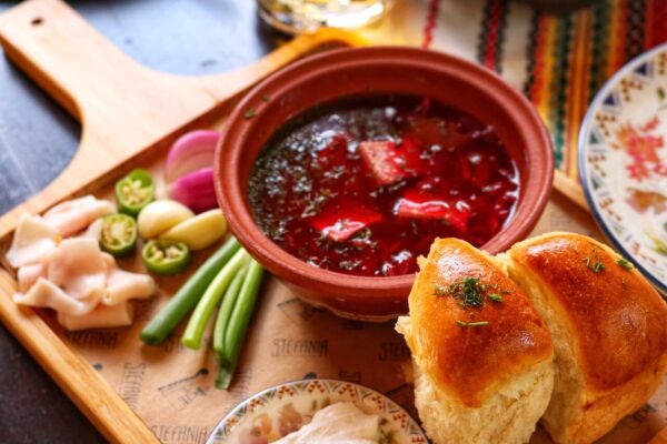Ukrainian borscht served with sour cream and garlic pampushky